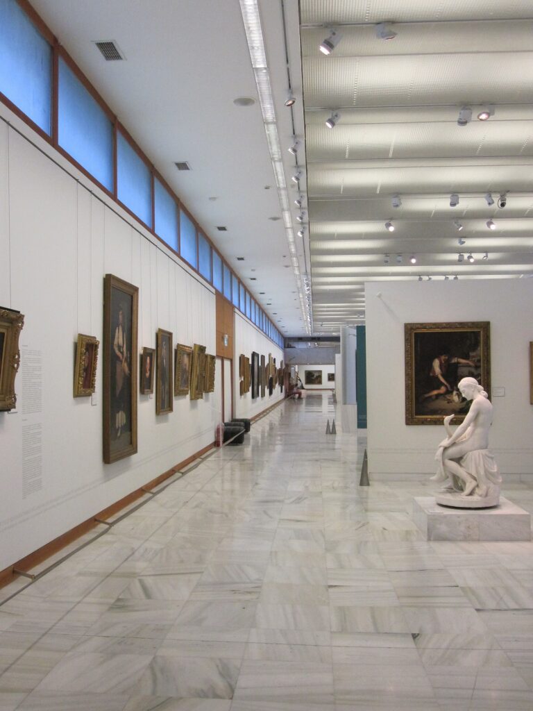A painting gallery at the National Gallery of Greece, Athens, with a marble sculpture on a plinth
